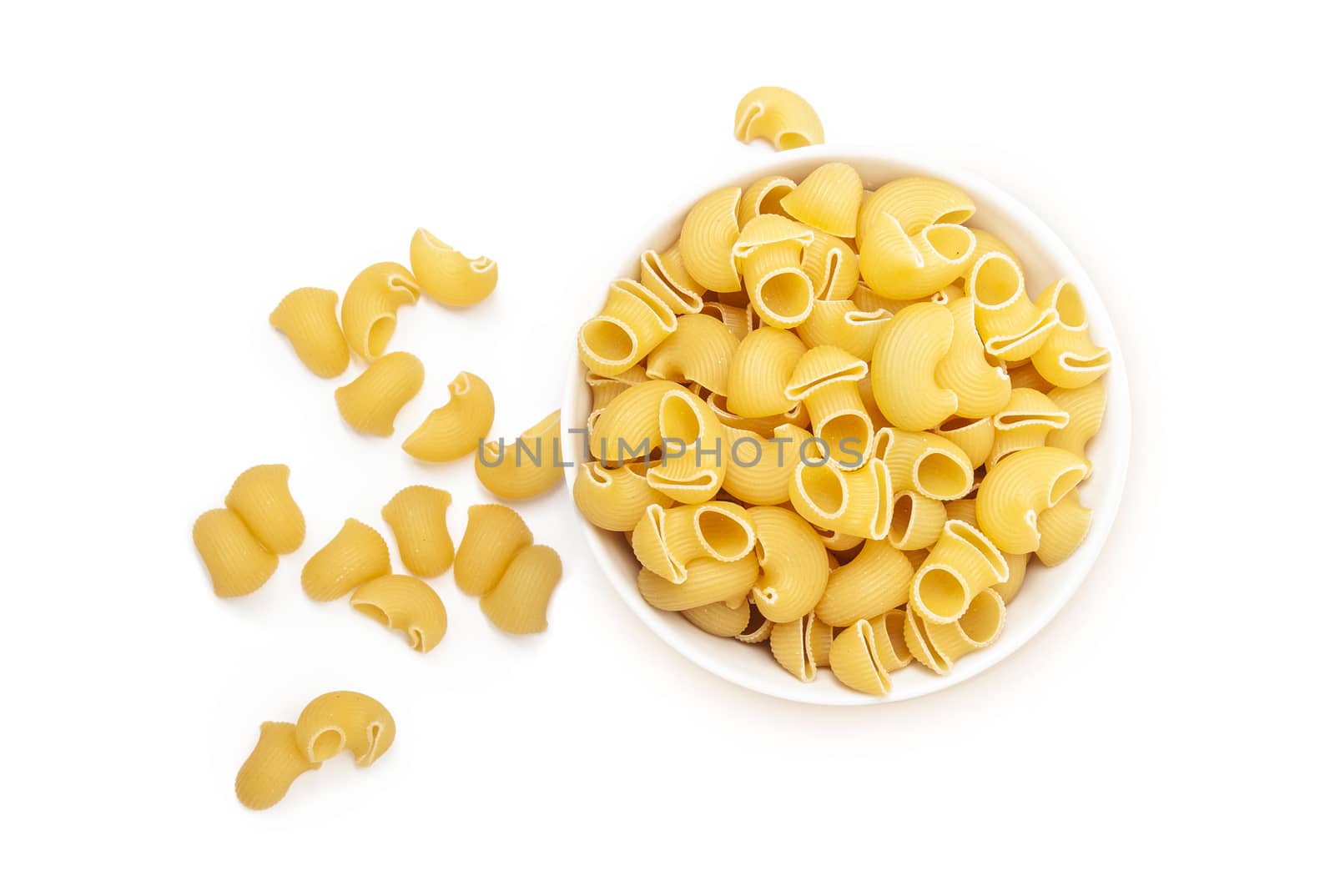 Pasta Pipe Rigate in a white bowl. Isolated on a white background. Top wiew
