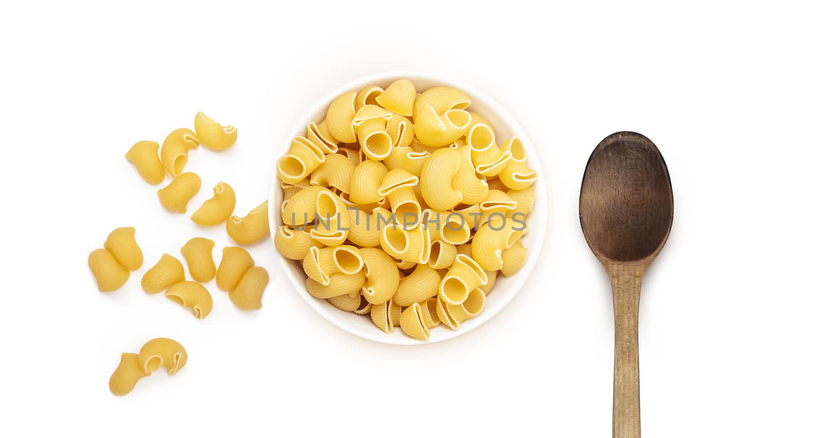 Pasta Pipe Rigate and old wooden spoon. Isolated on a white background. Top wiew