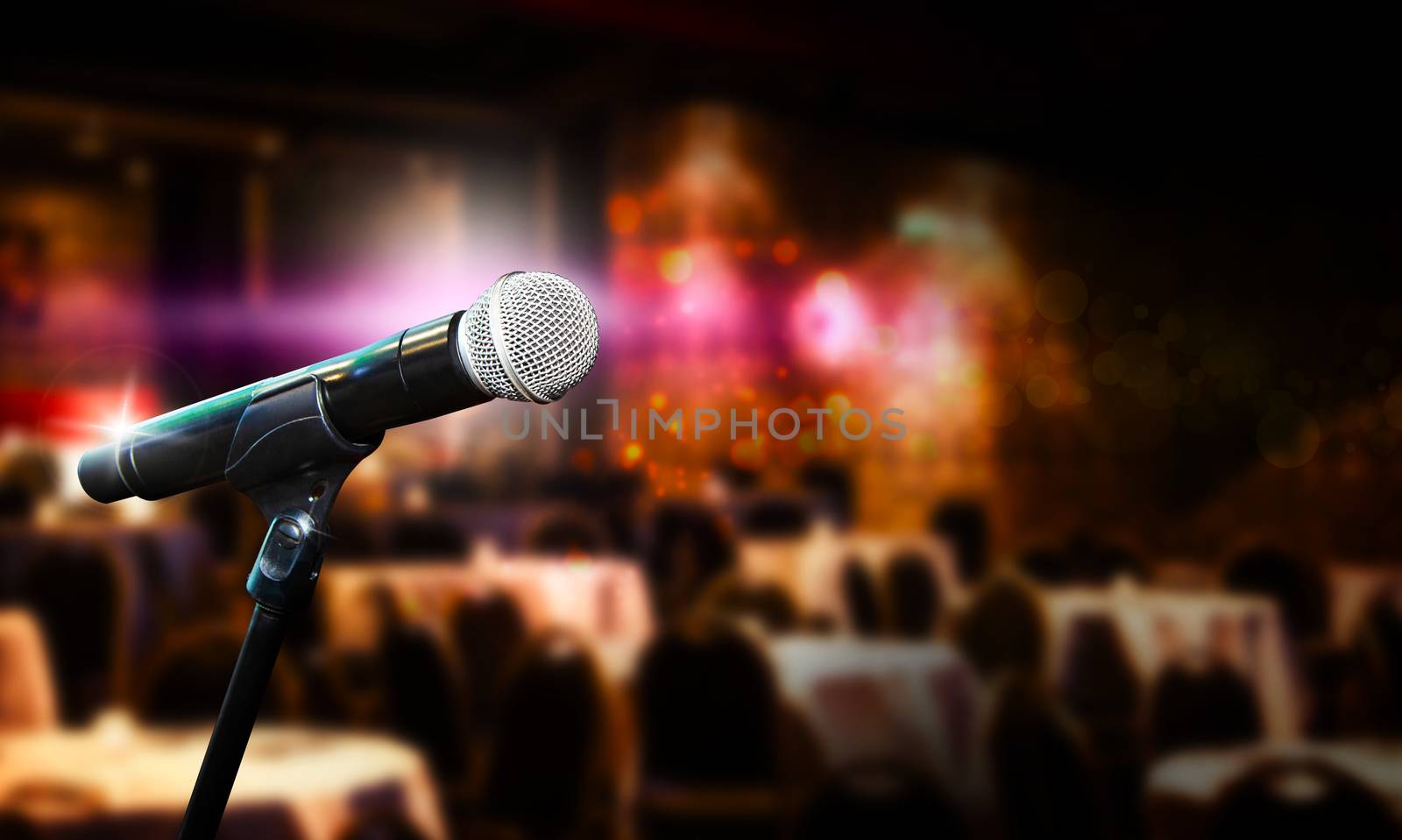 Close up of microphone in concert hall or conference room. Blurred concept