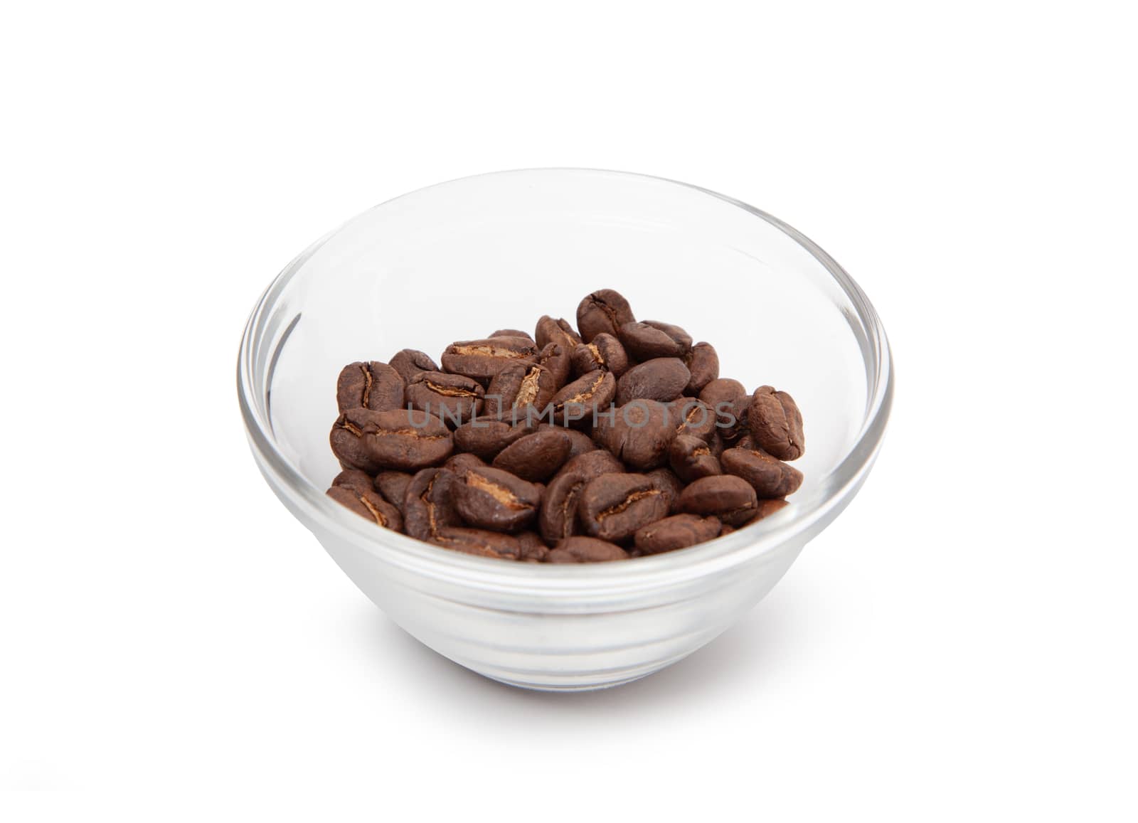 Roasted coffee beans in a glass bowl. Isolated in white background. Close up