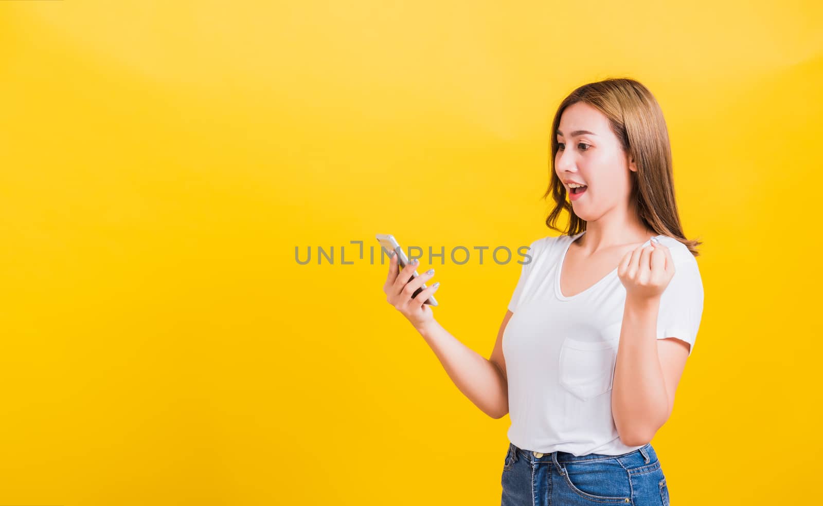 woman teen smiling standing wear t-shirt celebrating win with sm by Sorapop