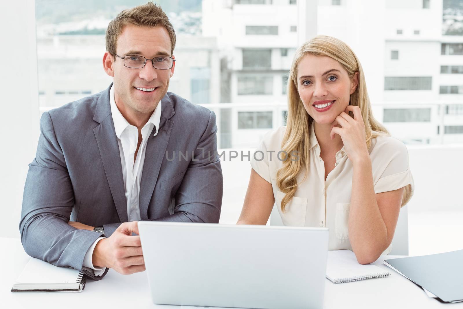 Portrait of business people with laptop at office