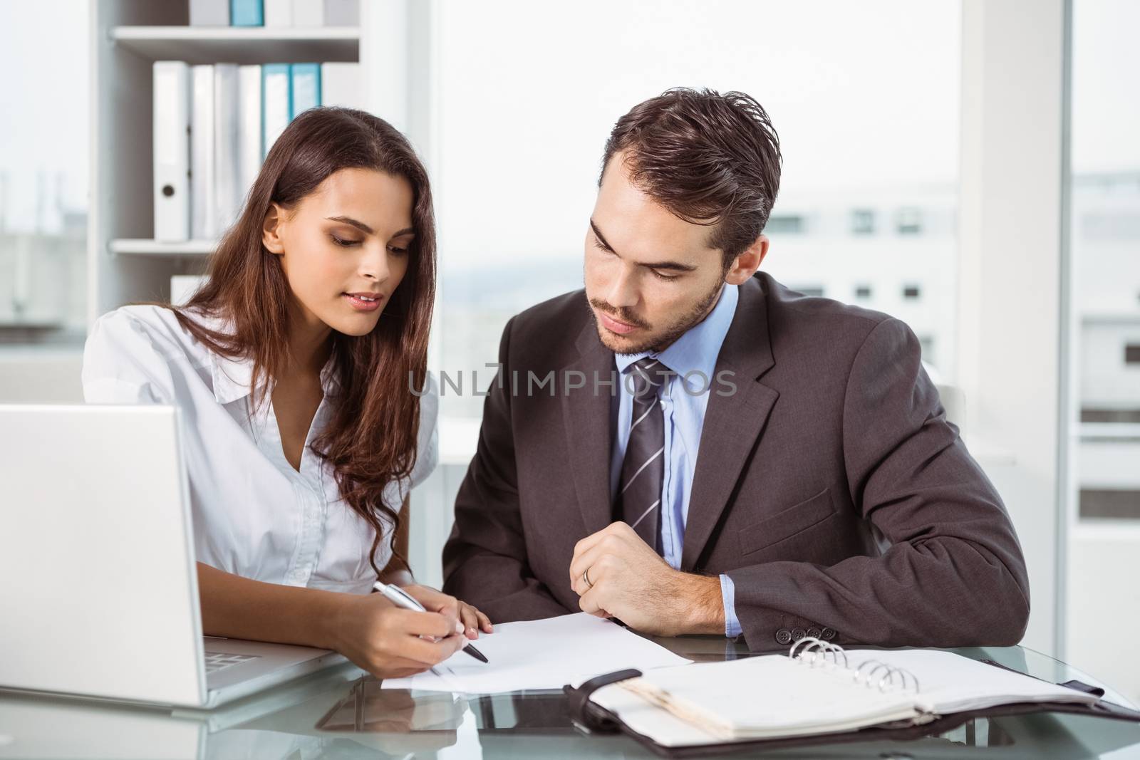 Two young business people in meeting at office