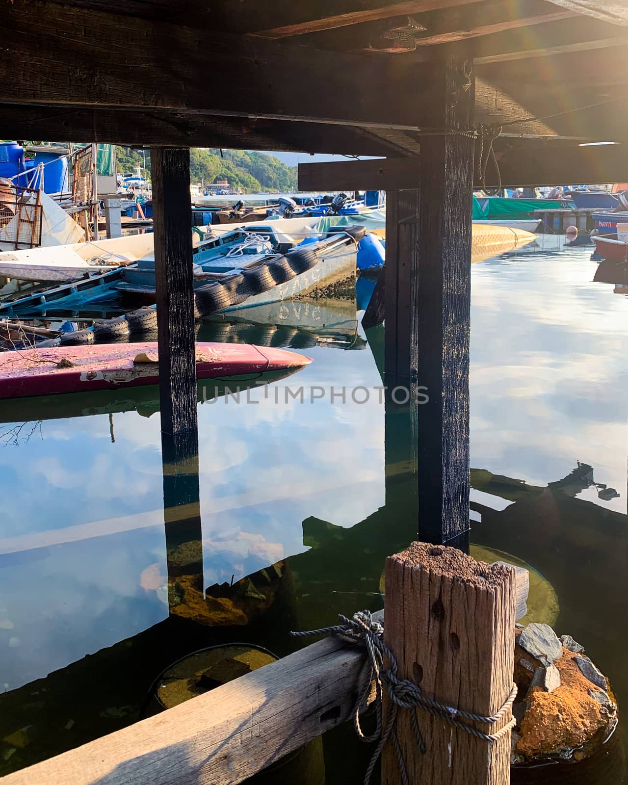 The fishing boats on the sea and wooden house in Hong Kong countryside