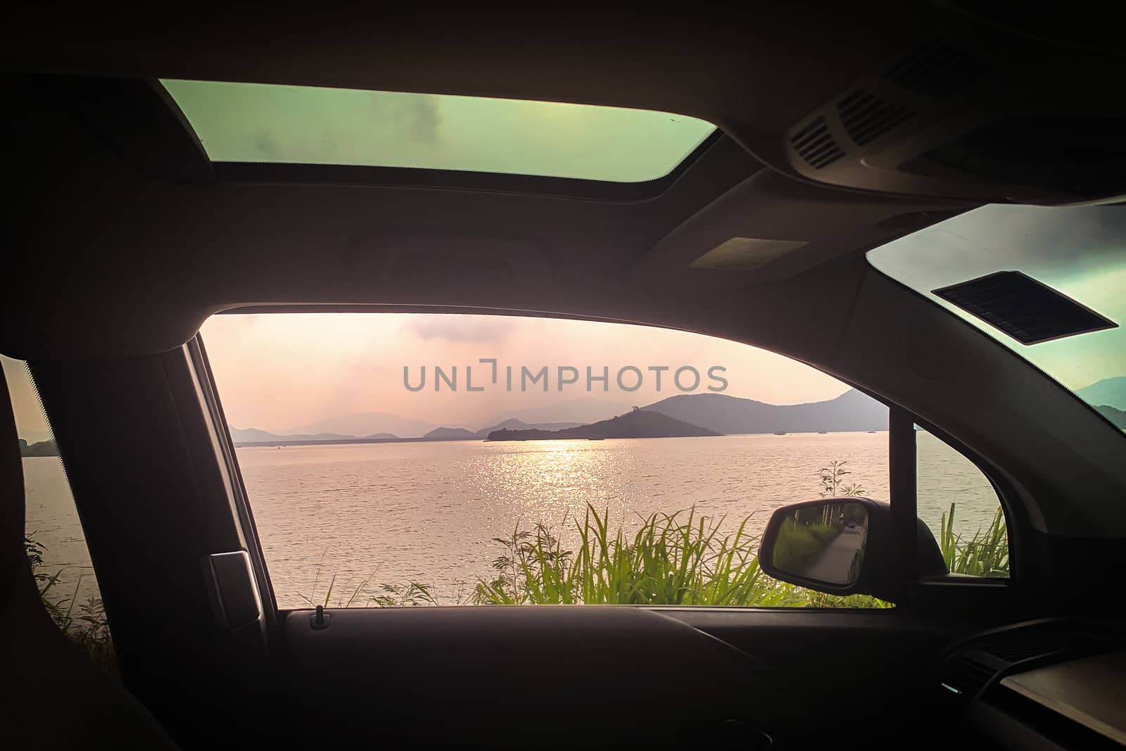 Interior car, mirror, sunroof, ocean, with sunlight reflection a by cougarsan
