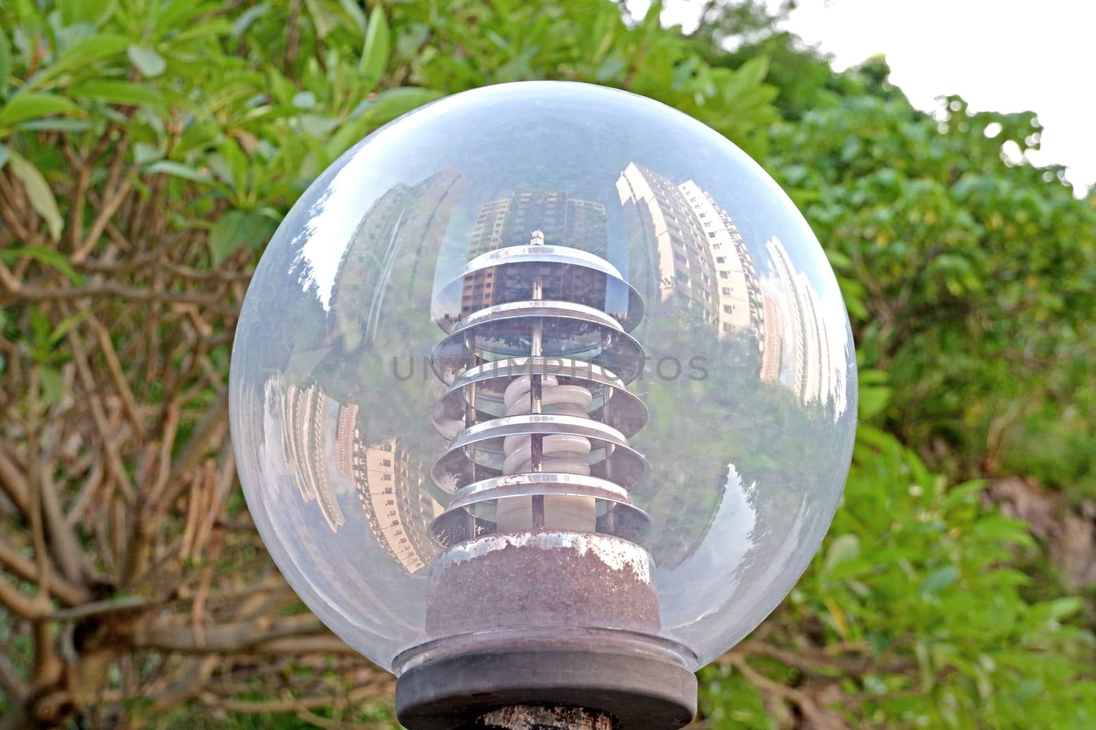 The reflection of residential apartment buildings on outdoor street lamp in Hong Kong