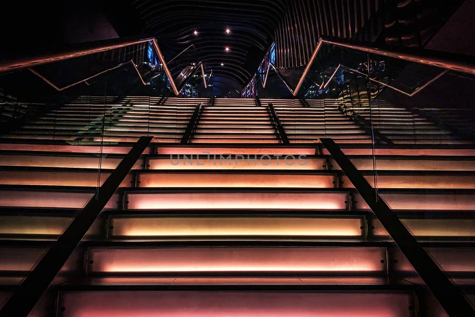 The inteior design of cinema light staircase with glass fence