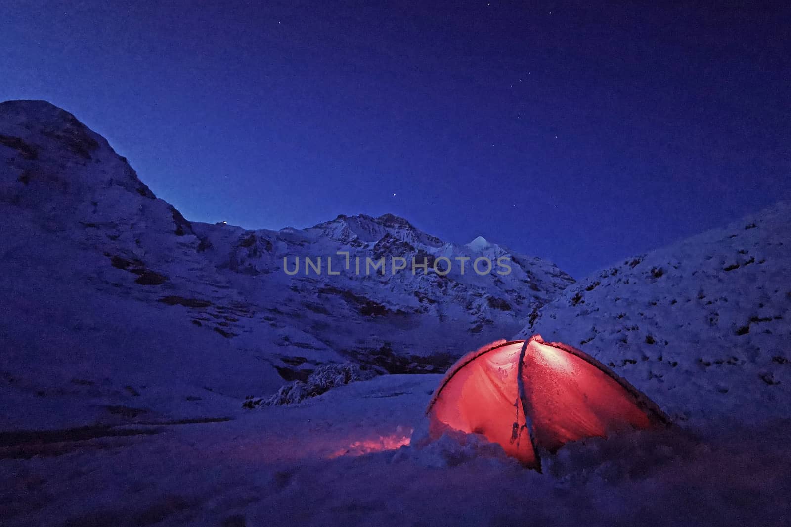 Outdoor red camping tent in Switzerland snow mountain by cougarsan