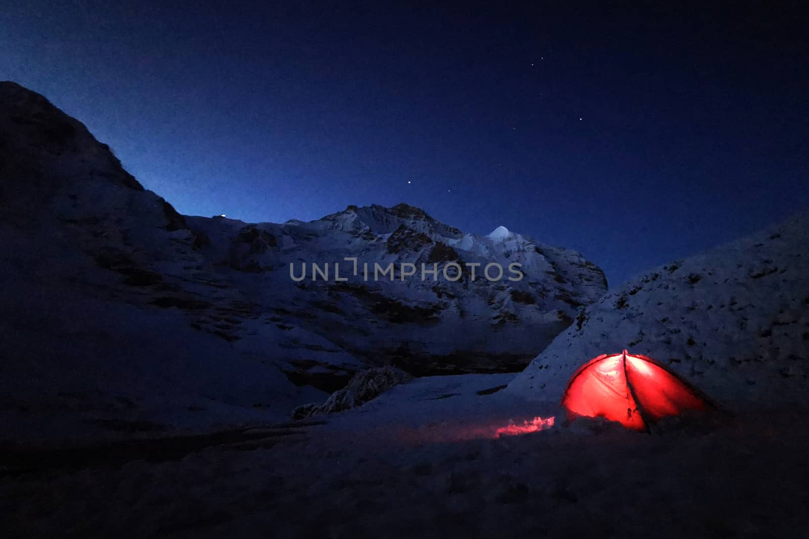 Outdoor red camping tent in Switzerland snow mountain by cougarsan