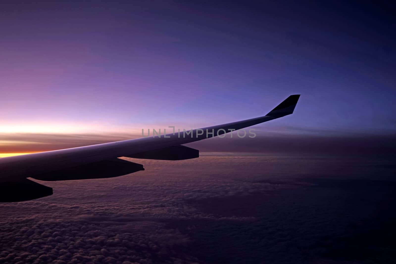 The plane, aeroplane wing, clouds,  gradient sky from aerial view