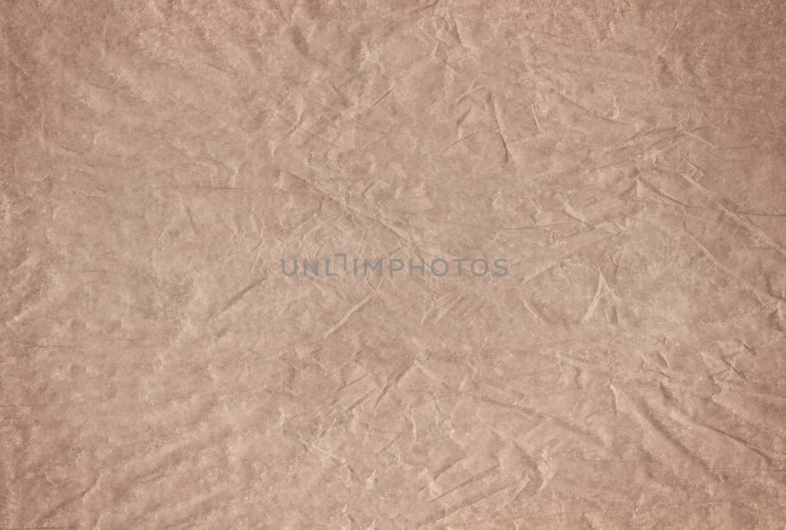 The Brown blank crumpled and grungy textured paper background