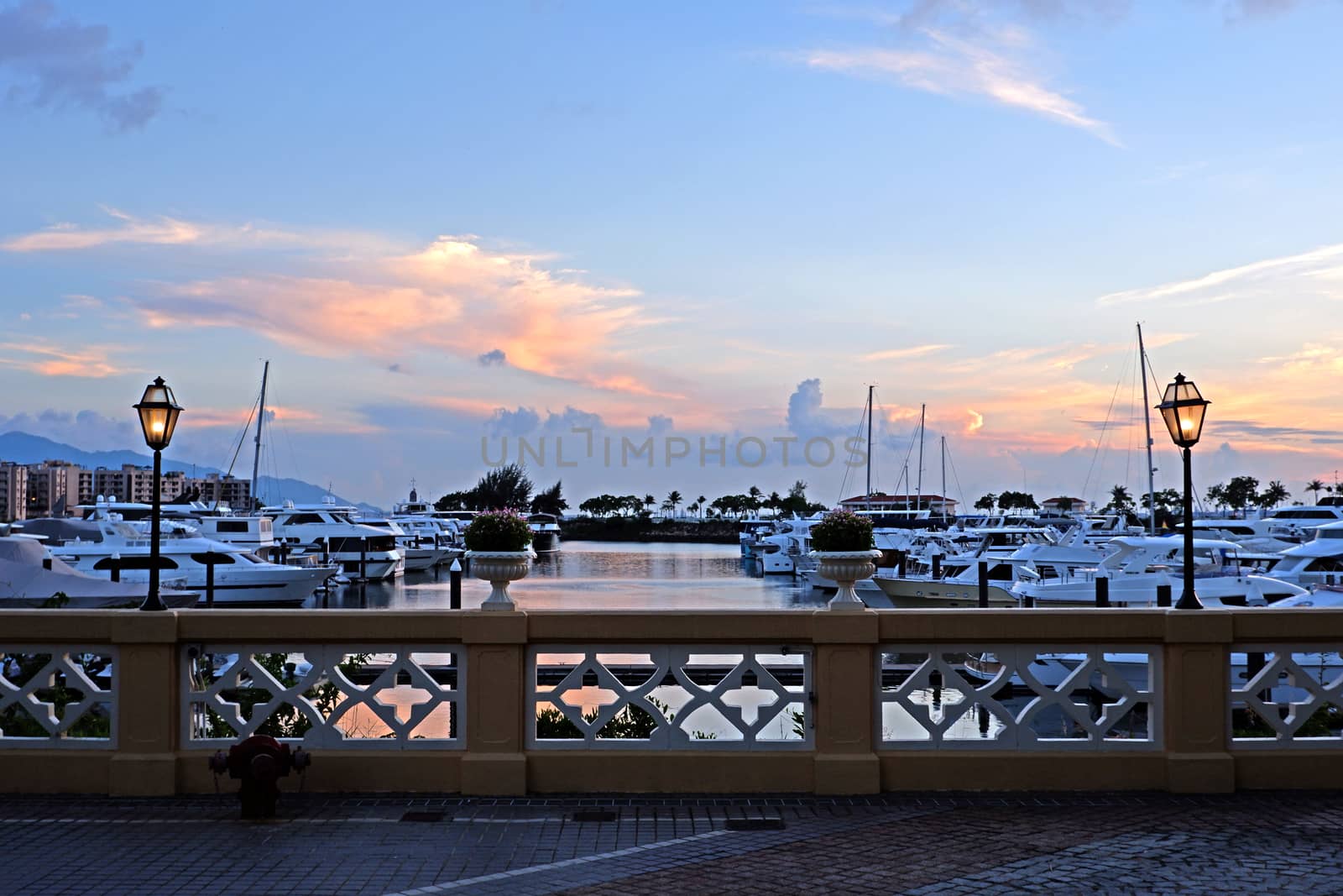 Luxury yacht, pier; building, cloudscape,, gradient sky at sunse by cougarsan