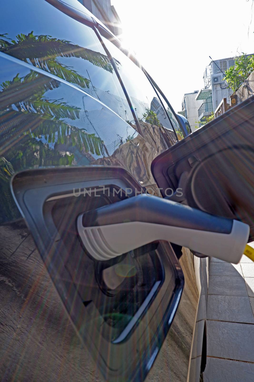 The close up of recharging cable and electric car 