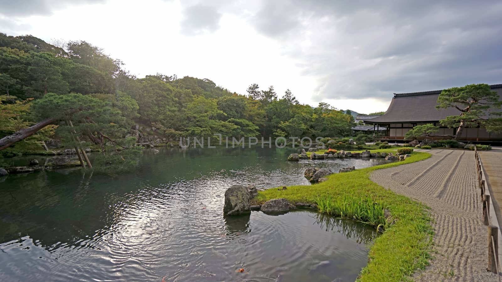 Historic buildings, lake, mountain in Japan Kyoto zen garden by cougarsan