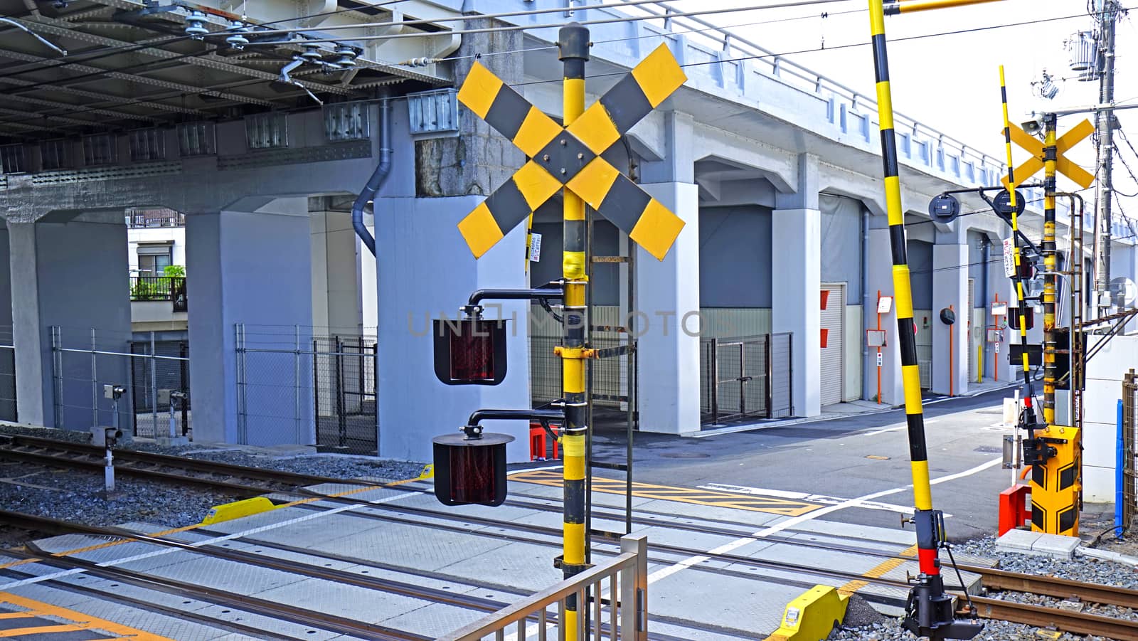 Outdoor train track with traffic alert light in Japan city by cougarsan