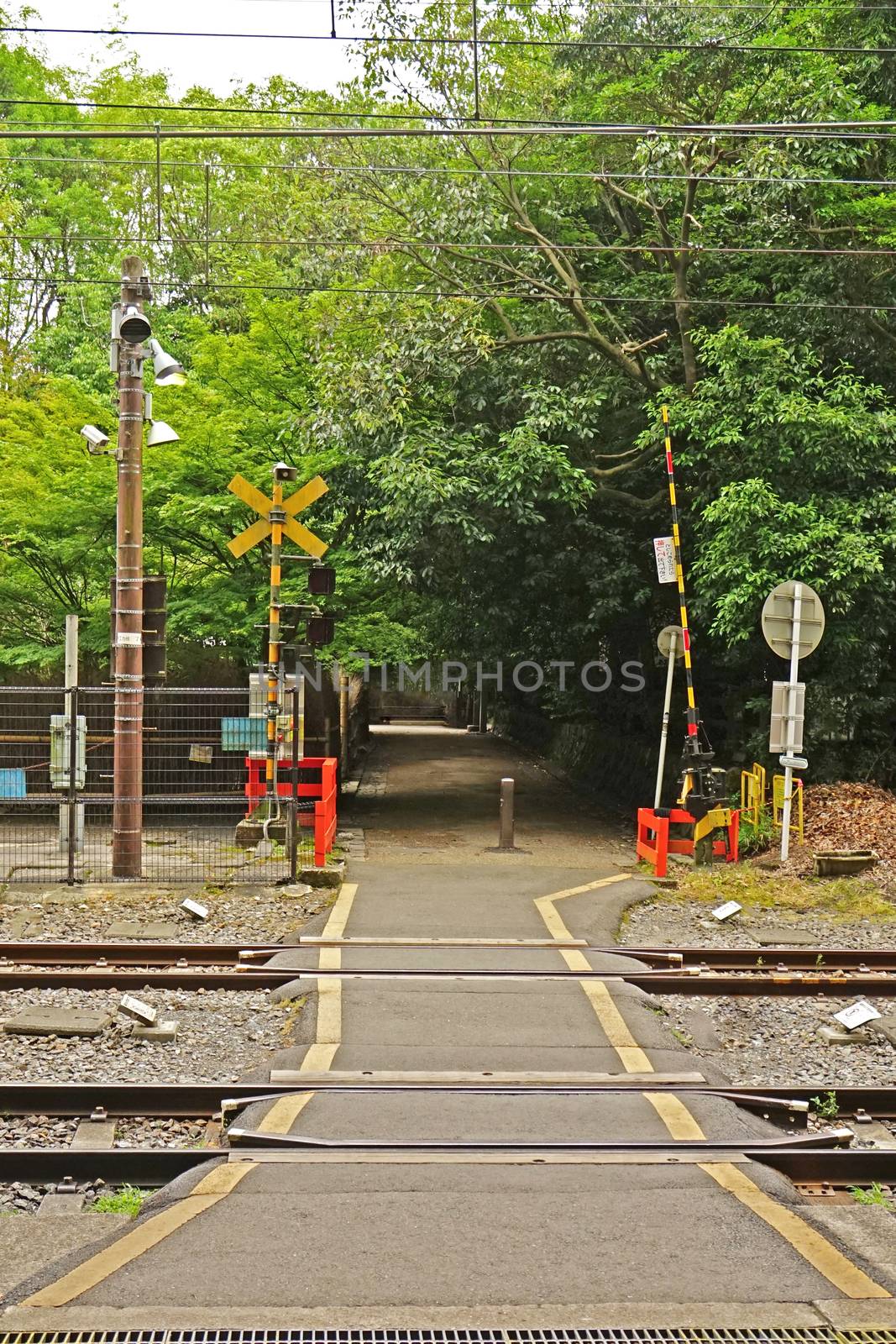 Outdoor train track with traffic alert light in Japan countrysid by cougarsan