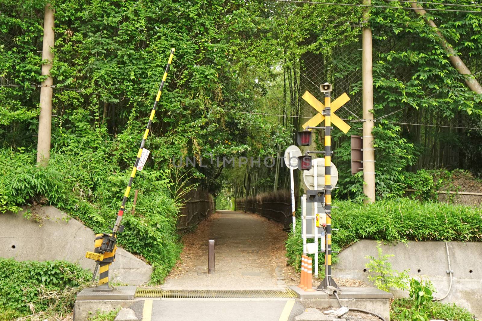 Outdoor train track with traffic alert light in Japan countrysid by cougarsan