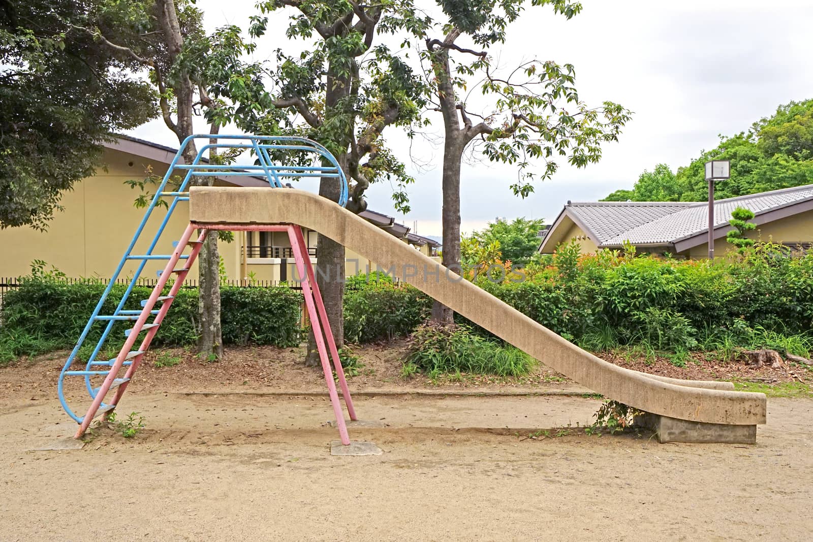 retro children slide equipment in Japan outdoor playround by cougarsan