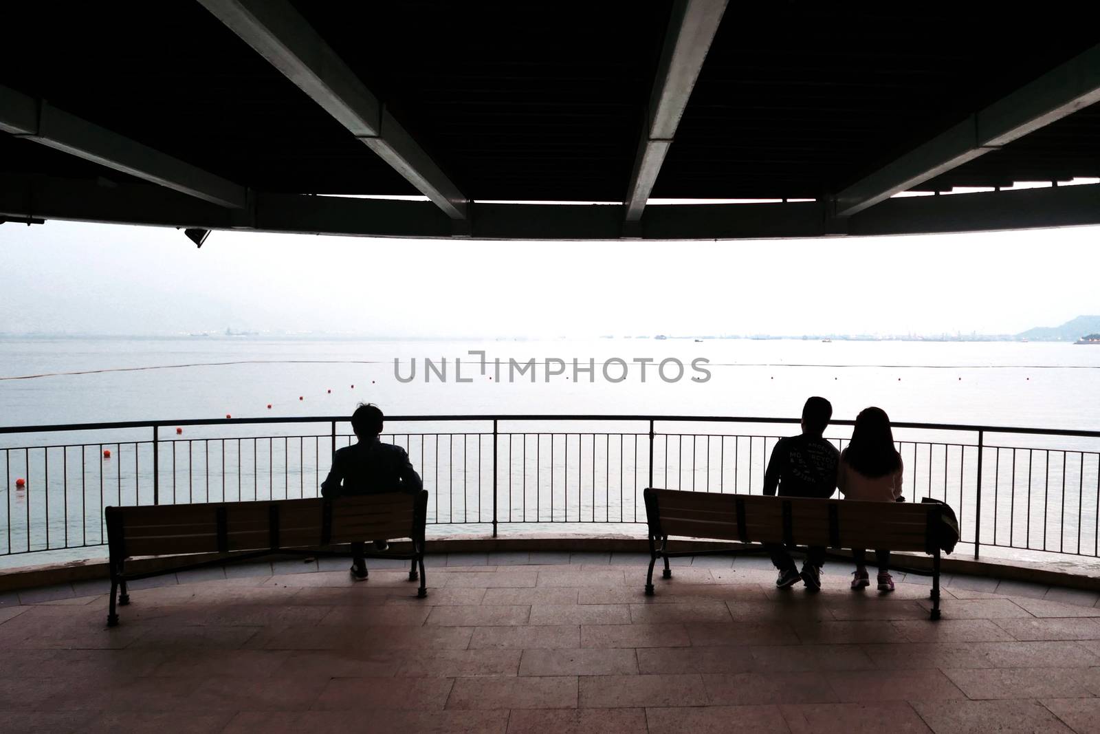 The silhouette of couple, man and the wooden bench