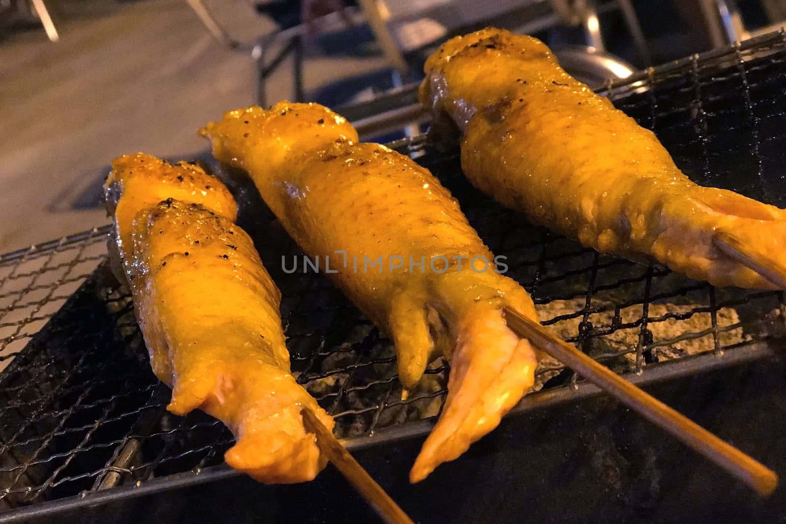 Outdoor barbecue chicken wing on the metal net grilled