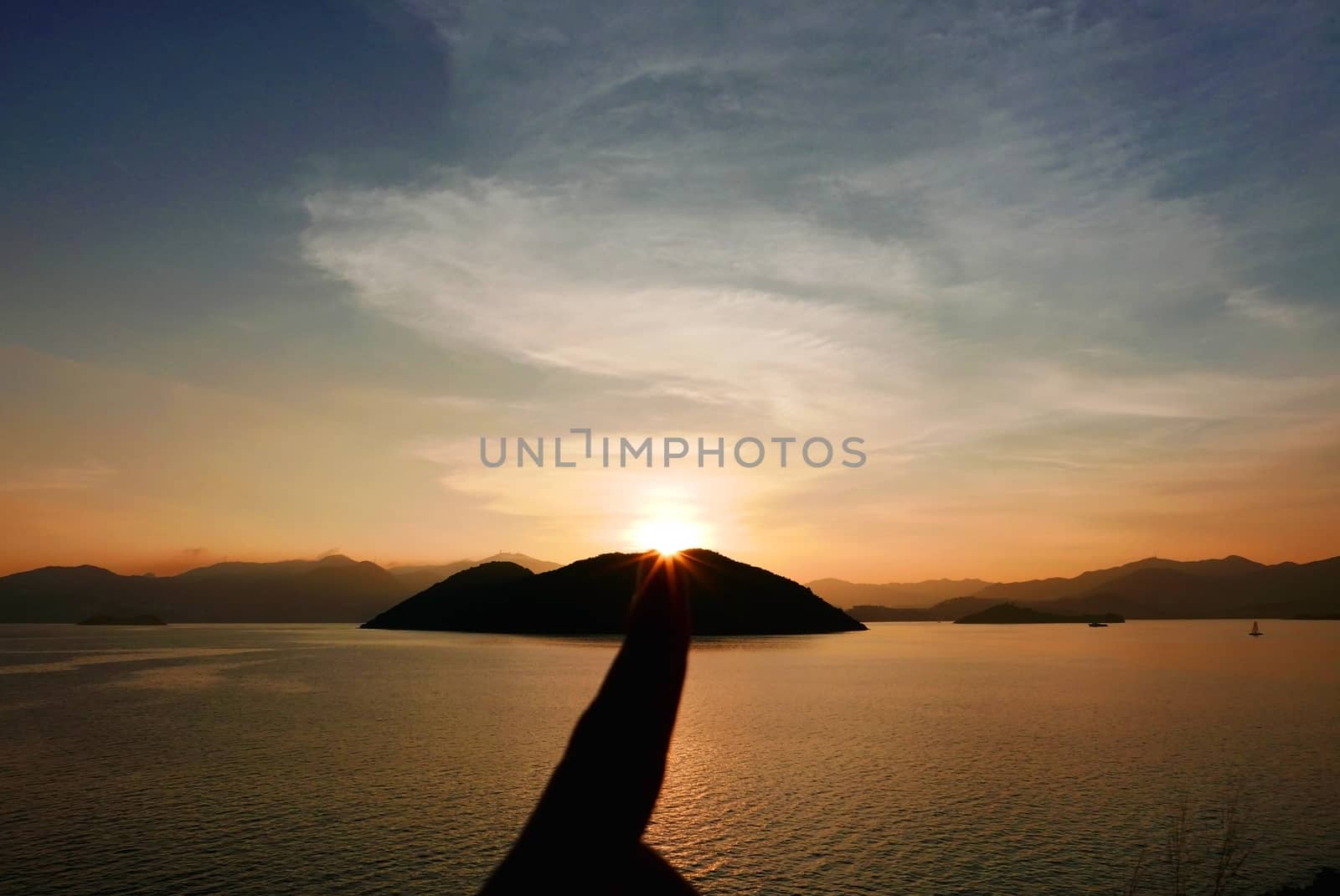 sun with sunlight, mountain, ocean at the sunset