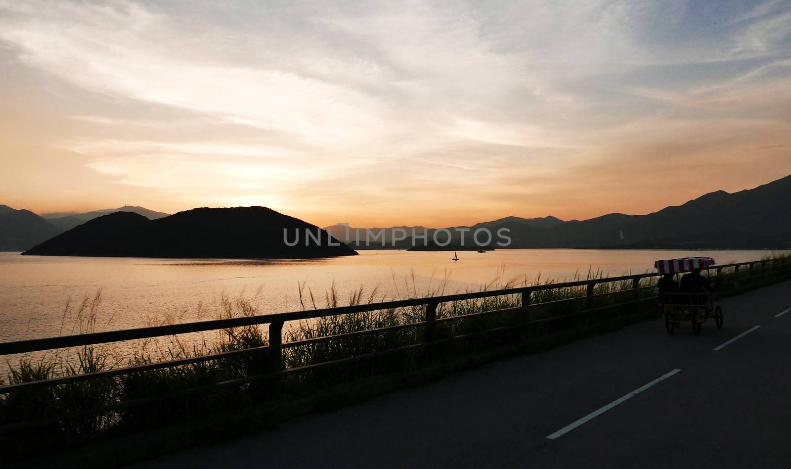 The silhouette of four wheels bicycle and the sunset