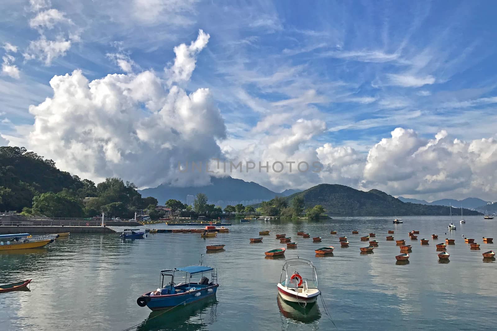 The mountain, blue sky, boats, yacht and sailboats near the park