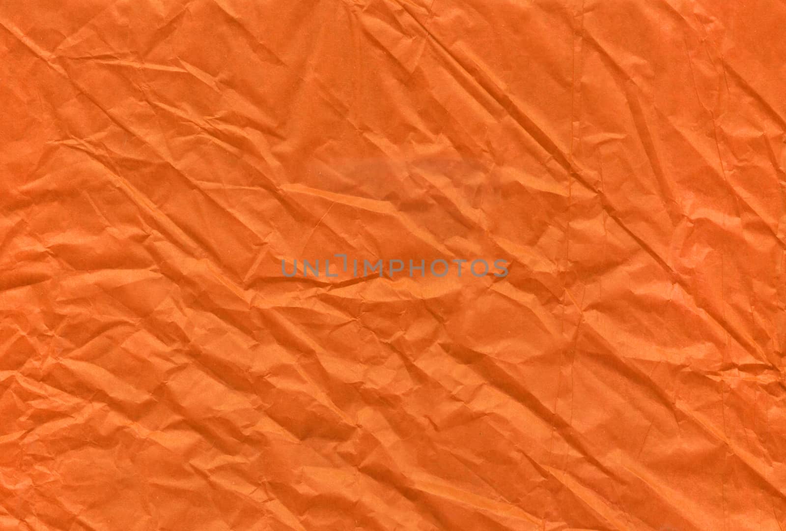 The Halloween orange crumpled and grungy textured blank paper background