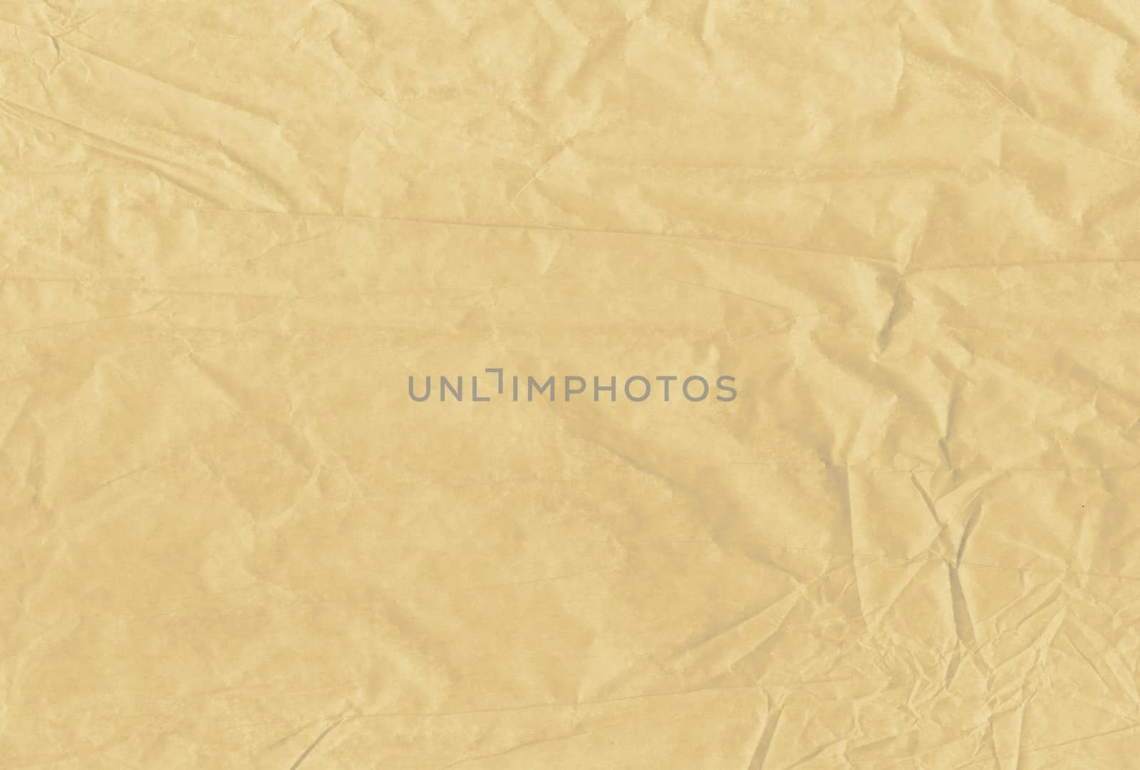 The light brown blank crumpled and grungy textured paper background