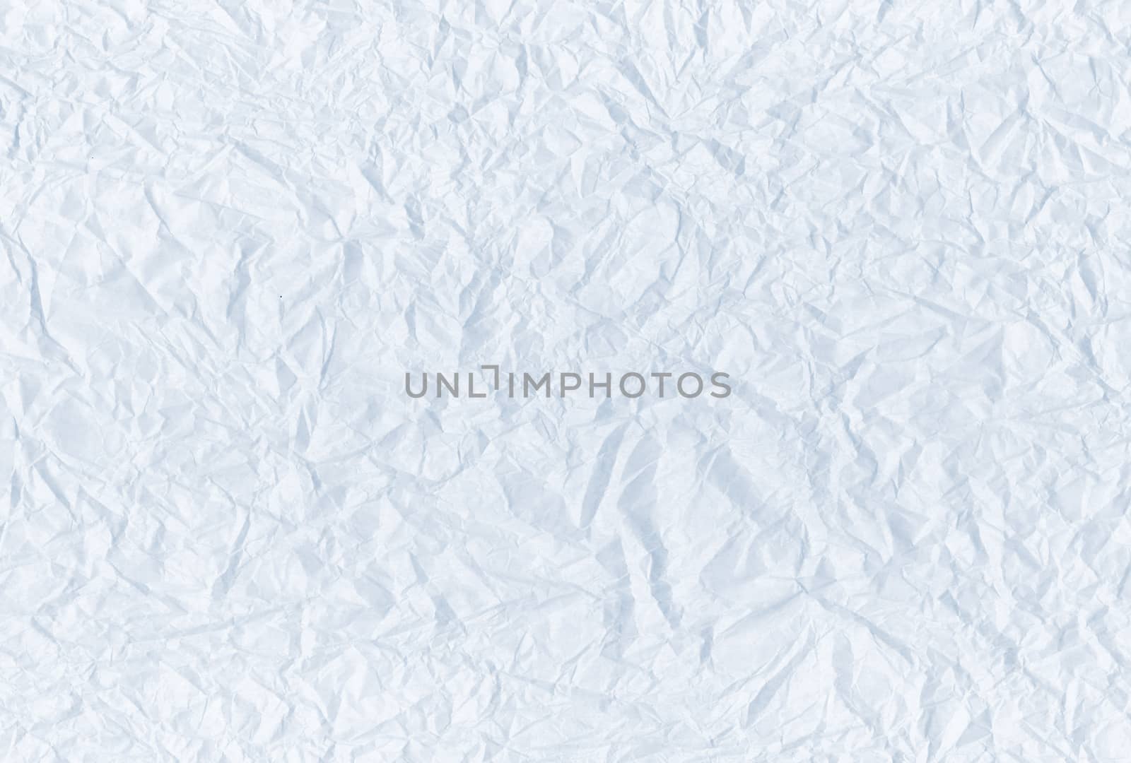 The light blue blank crumpled and grungy textured paper background