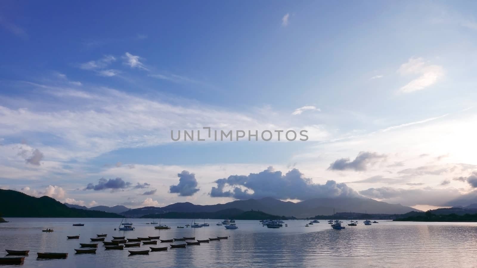 Boat, lake, mountain, blue sky and the clouds