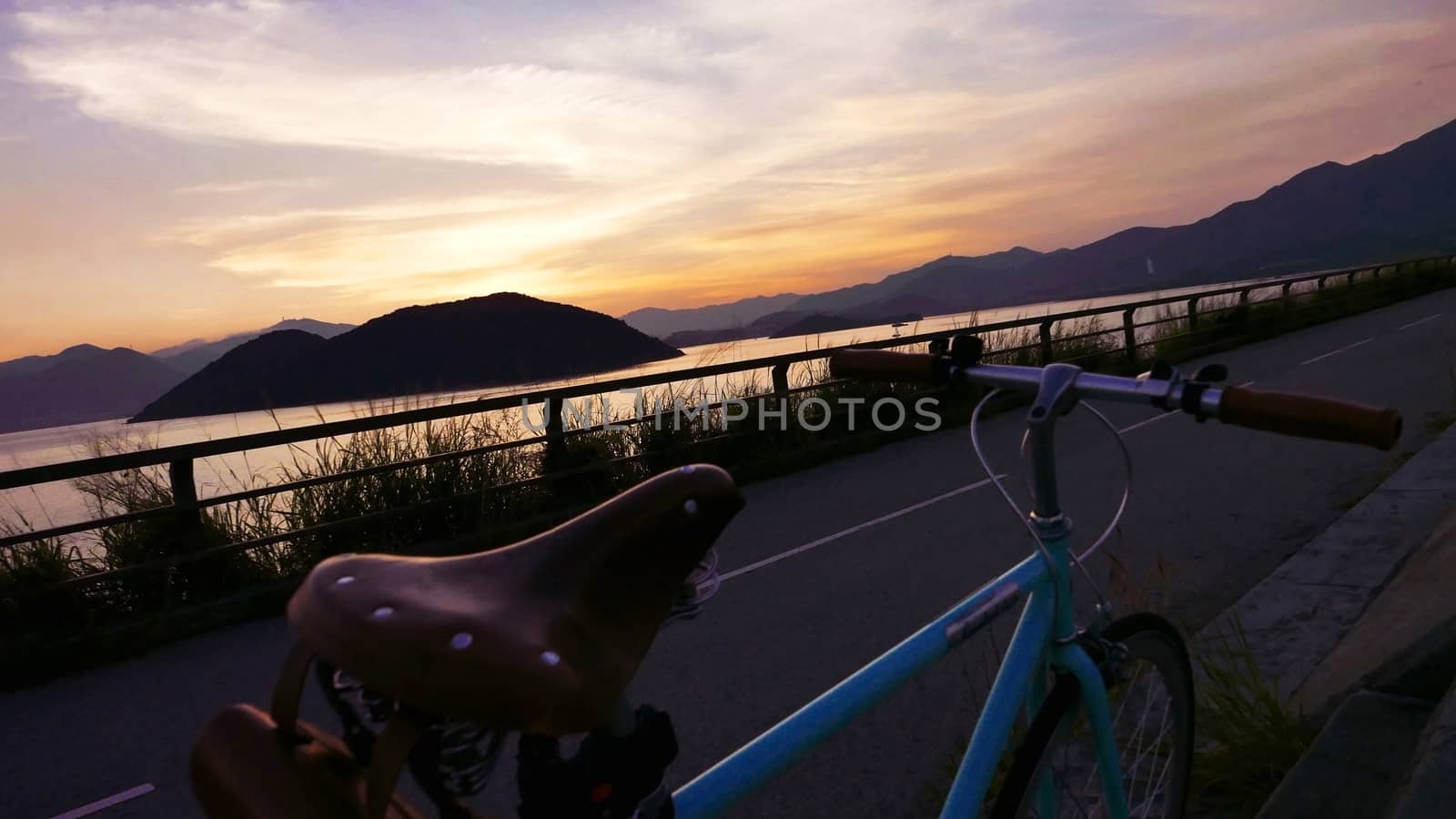 The part of retro bicycle and the frame silhouette at sunset by cougarsan