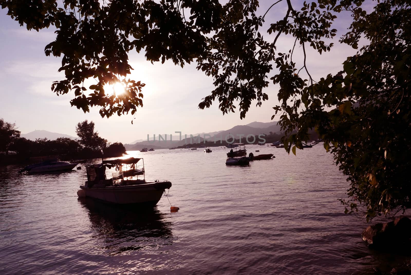 Silhouette of fishing boat on the lake by cougarsan