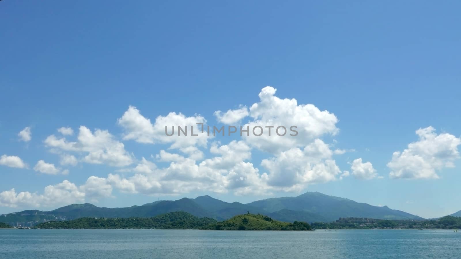 Green mountain, lake, blue sky and the white cloud