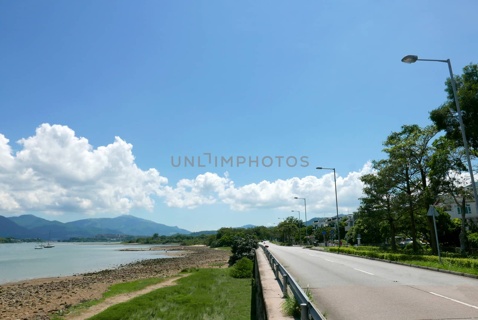 Sailboat, lake, road in the countryside with clean sky by cougarsan