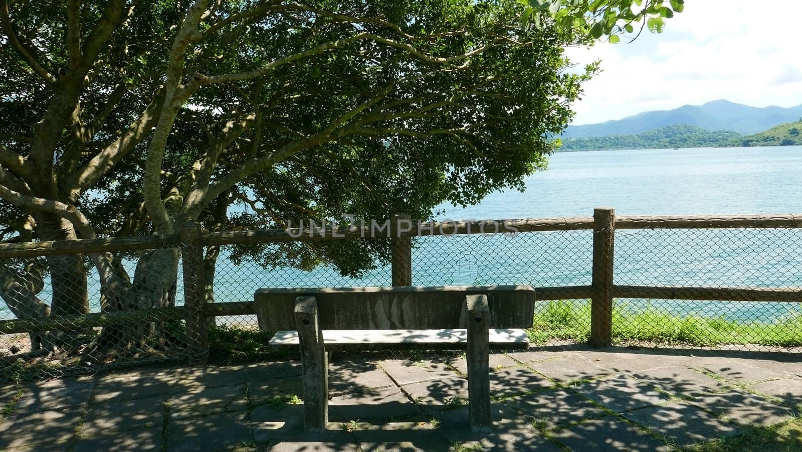 Outdoor wooden fence, bench, mountain and tree