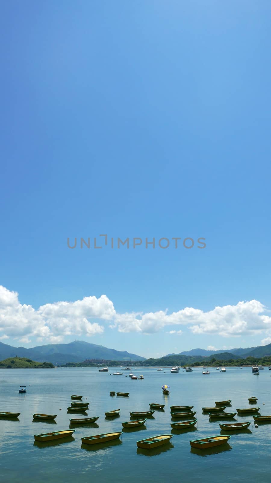 Vertical recreational Boat, lake, white cloud and the blue sky