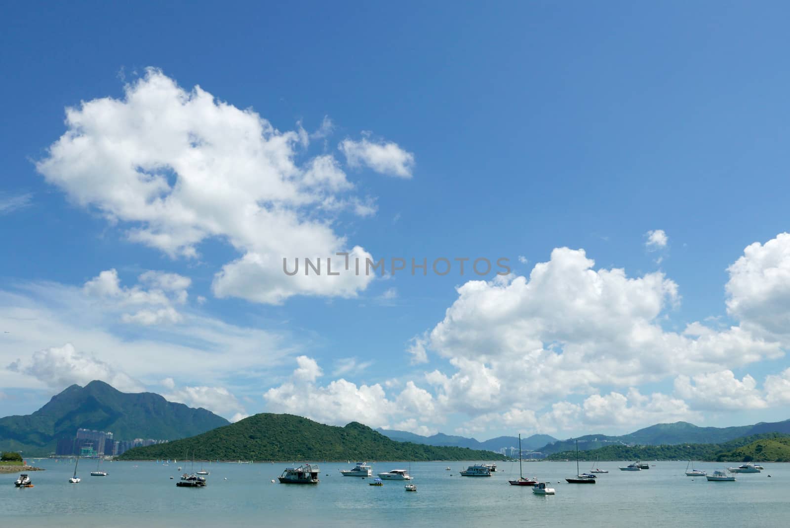 Motorboat, lake, mountain, blue sky and white cloud by cougarsan