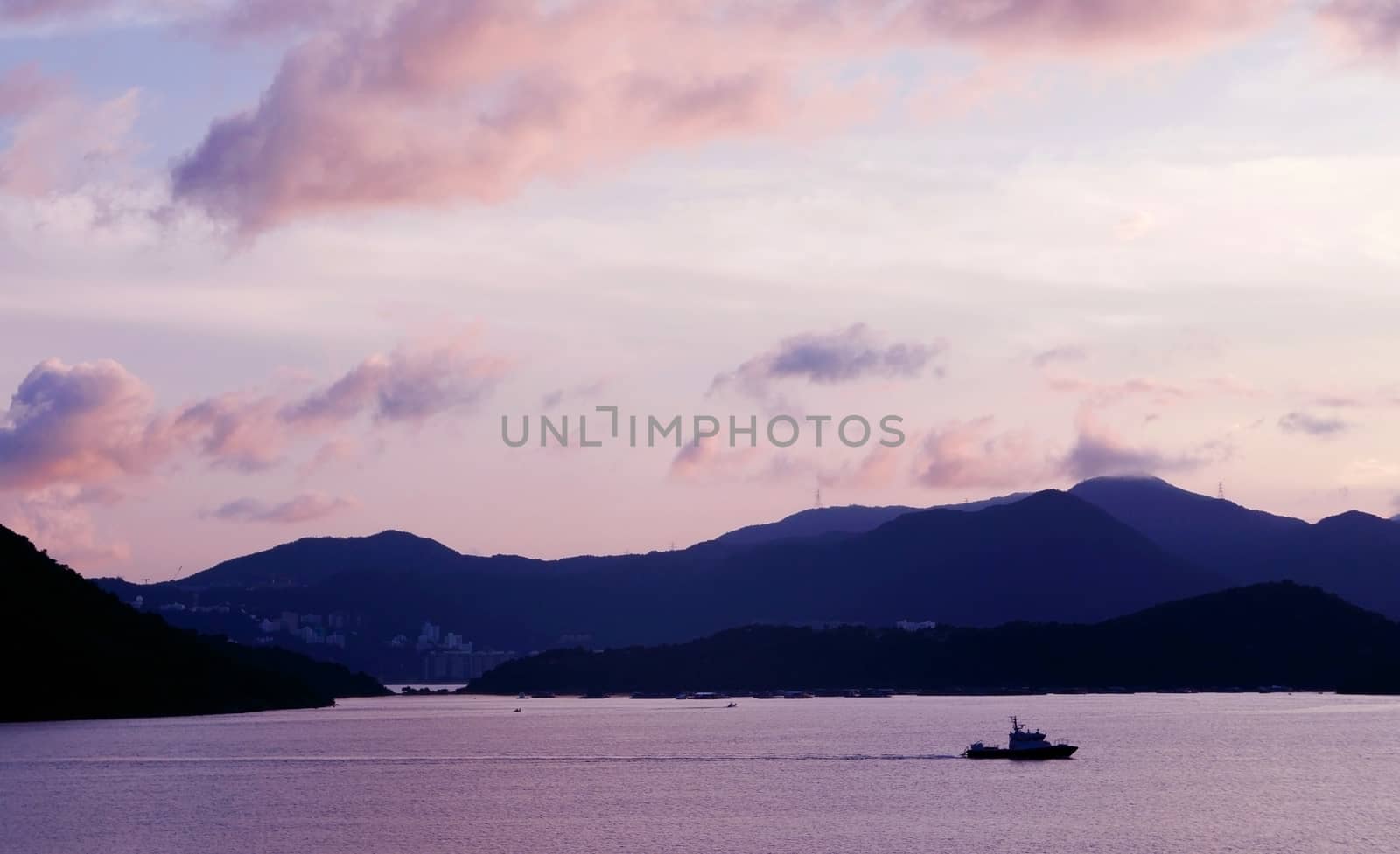 mountain, sky, boat on the sea at sunset