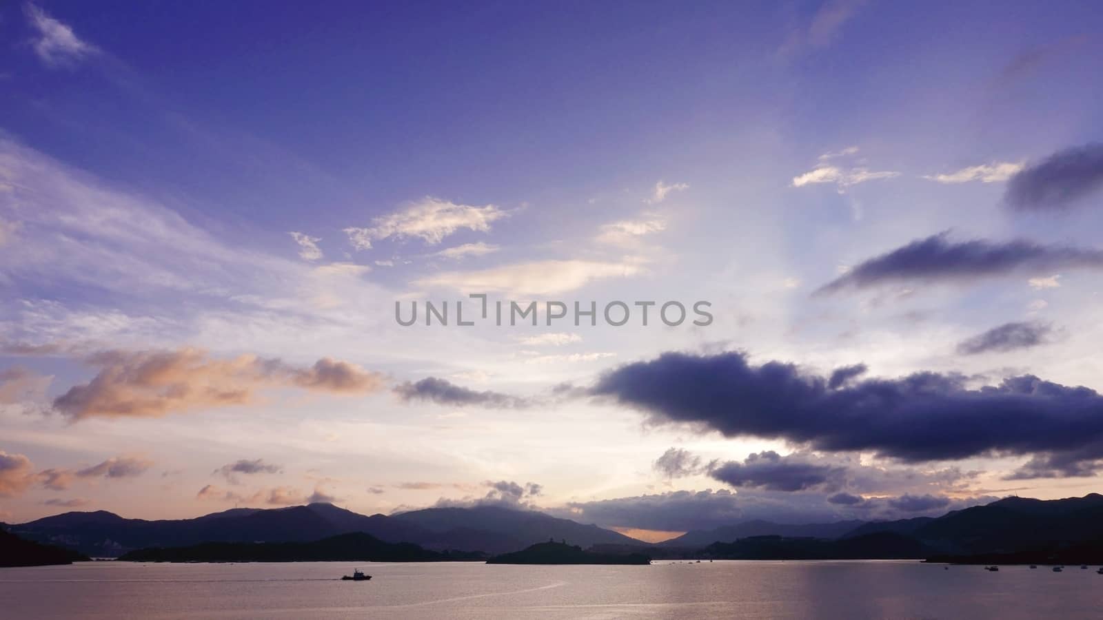 mountain, cloudscape sky, boat on the sea at sunset