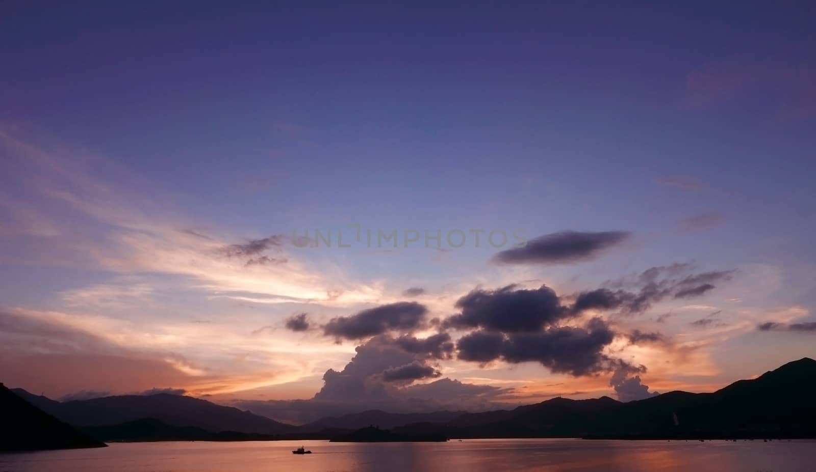 mountain, dramatic sky, boat on sea at sunset by cougarsan