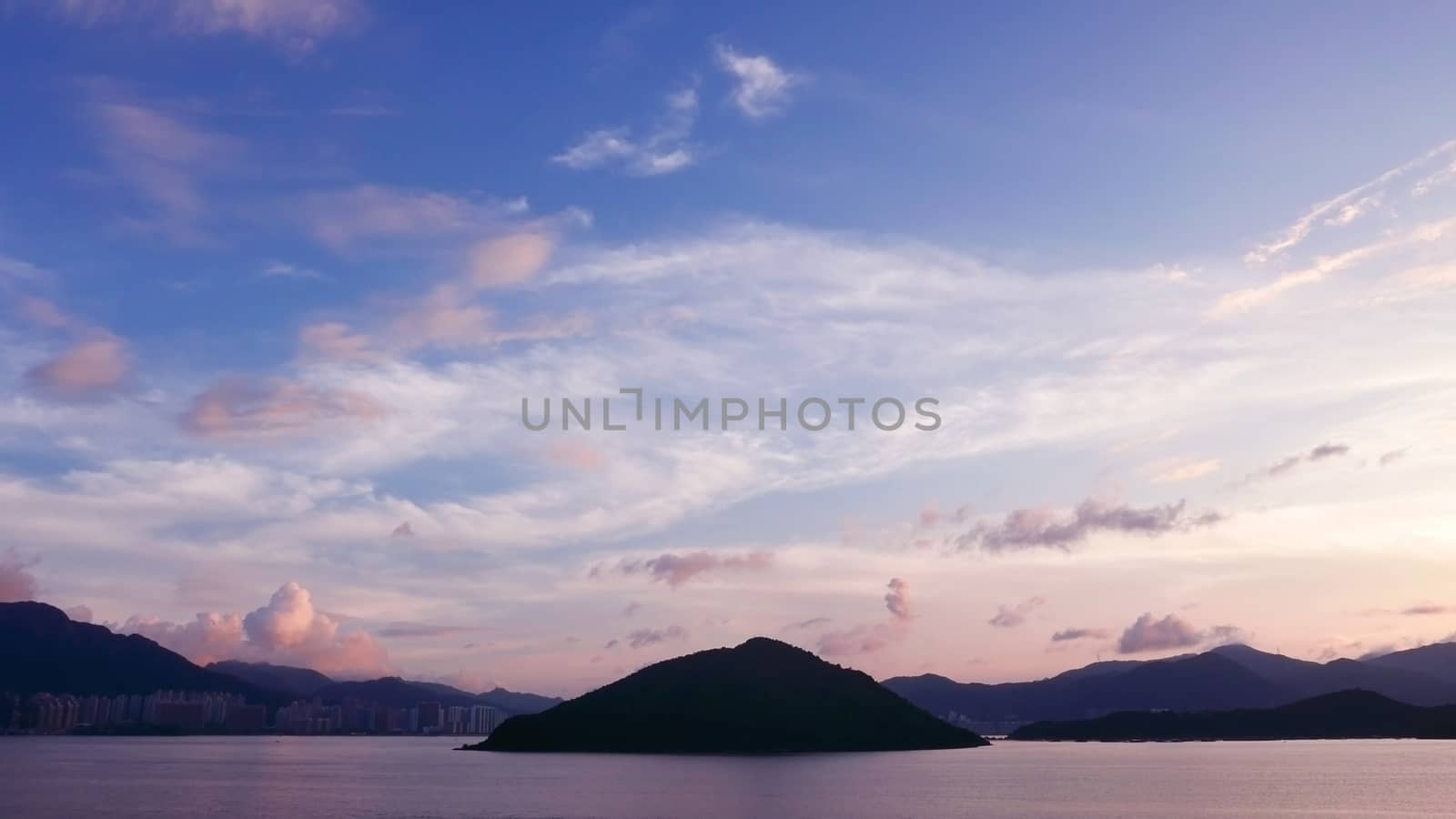 mountain, building, dramatic sky and the sea at sunset