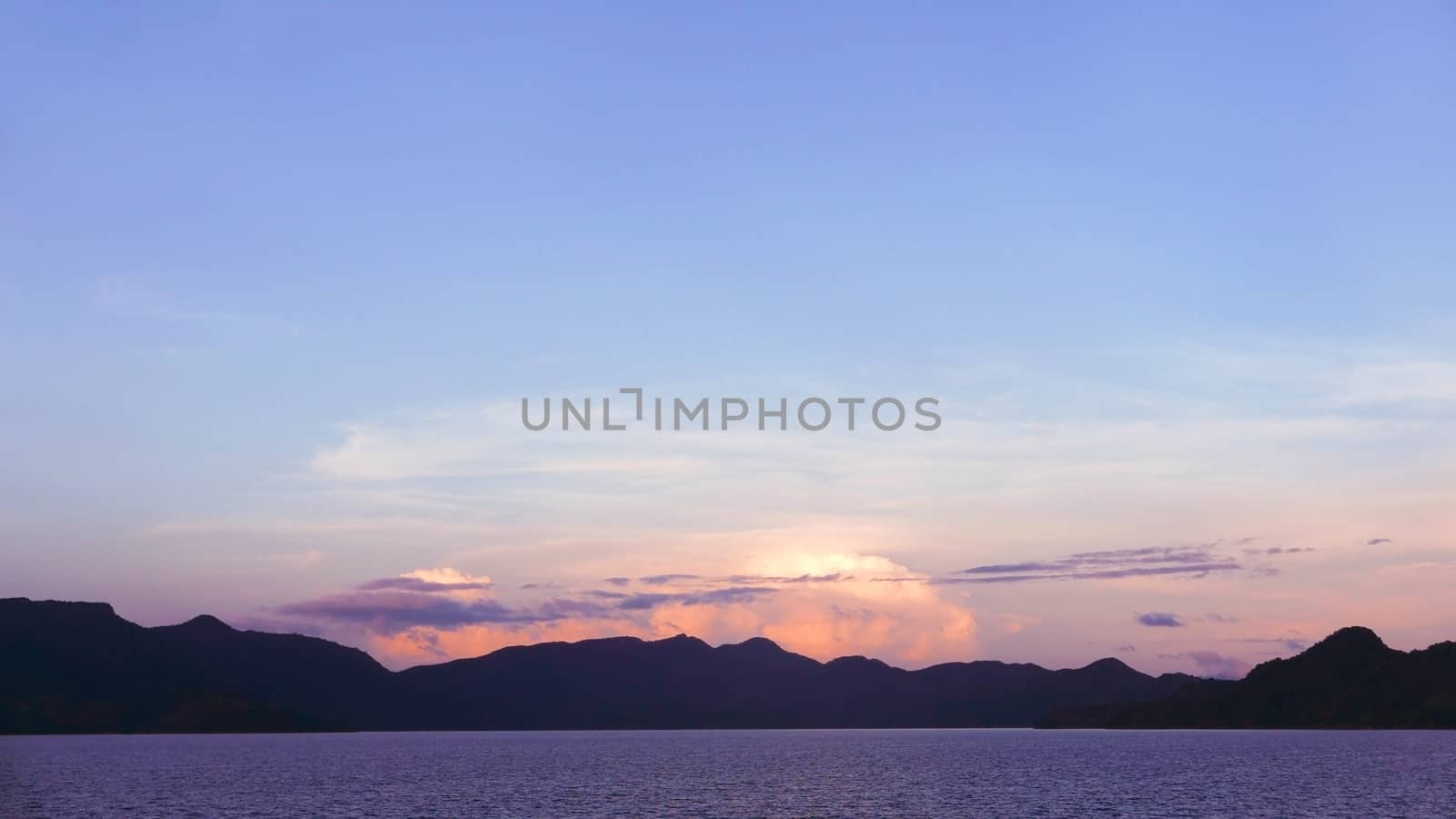 mountain, dramatic sky and ocean at sunset by cougarsan