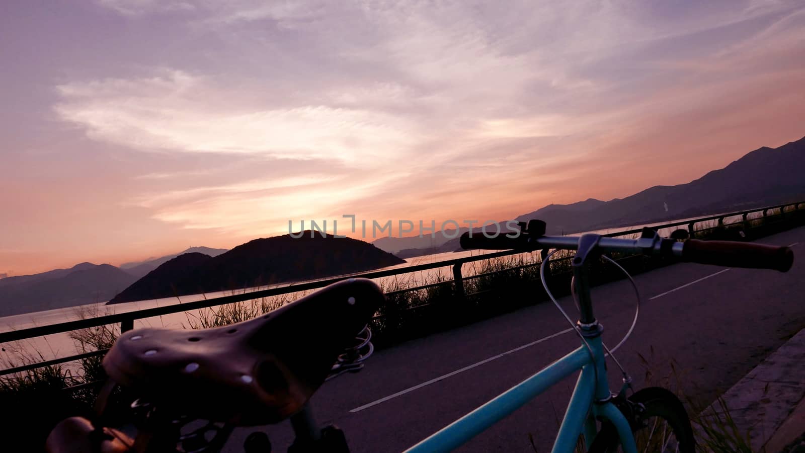 The part of retro bicycle and the frame silhouette at the sunset