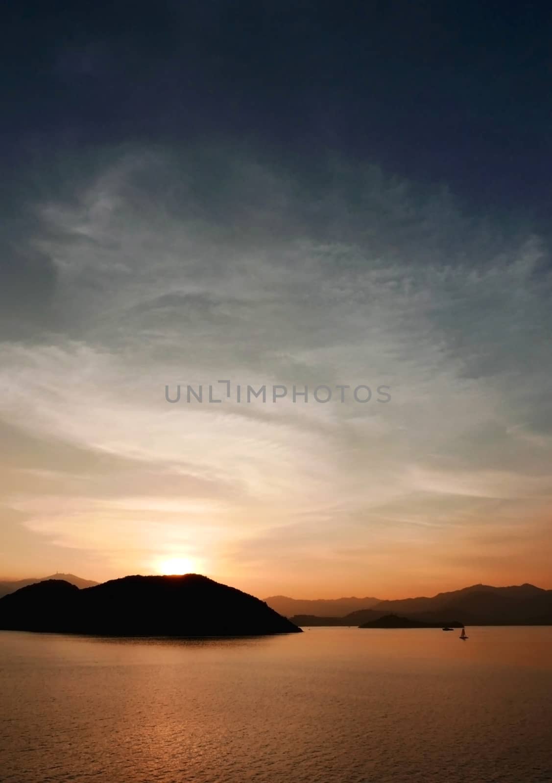 Vertical mountain, ocean, cloud and the gradient sky at sunset