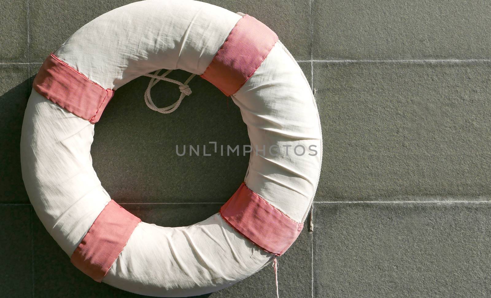 Red and white lifesaver near swimming pool by cougarsan