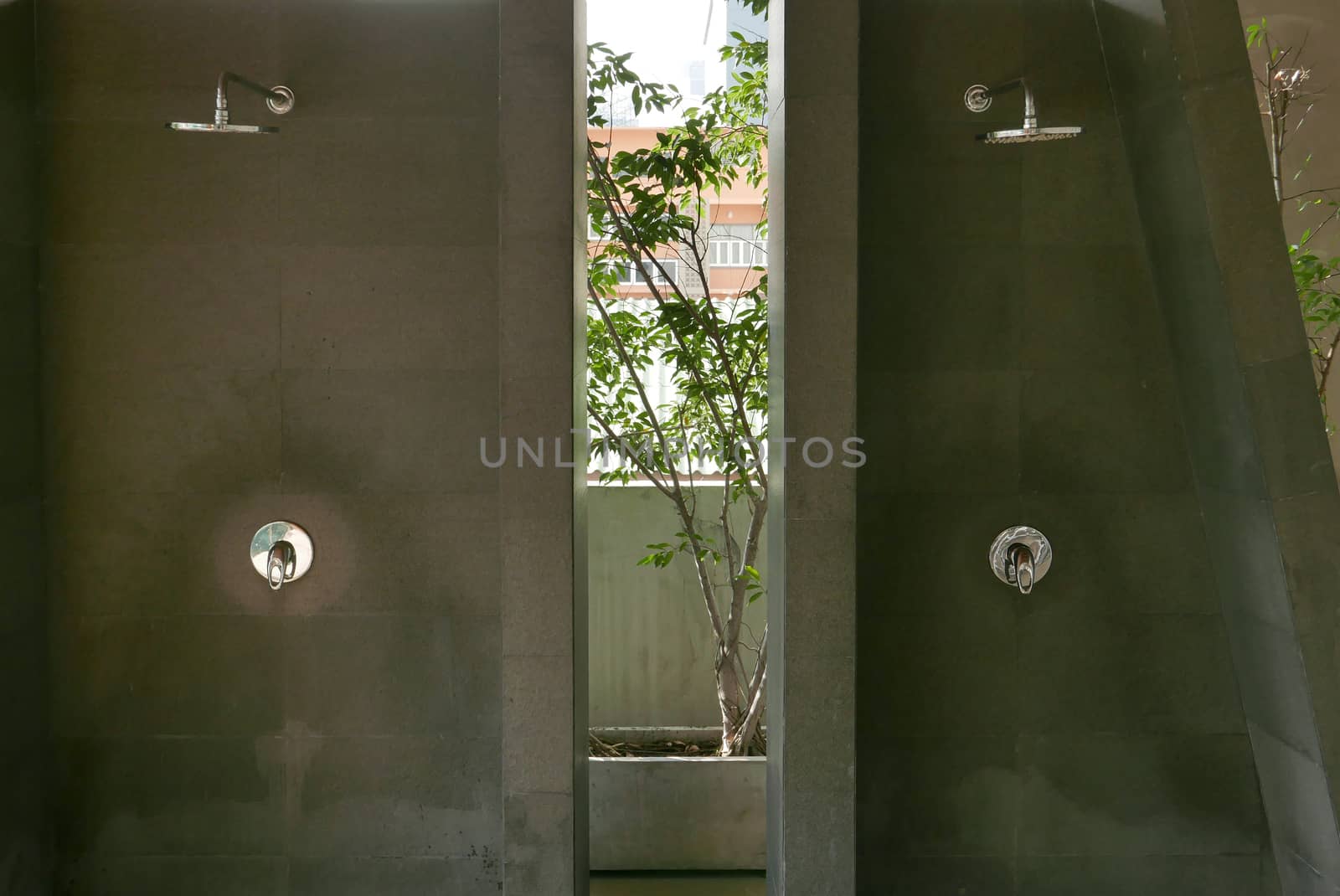 Two shower heads in the outdoor swimming pool bathroom