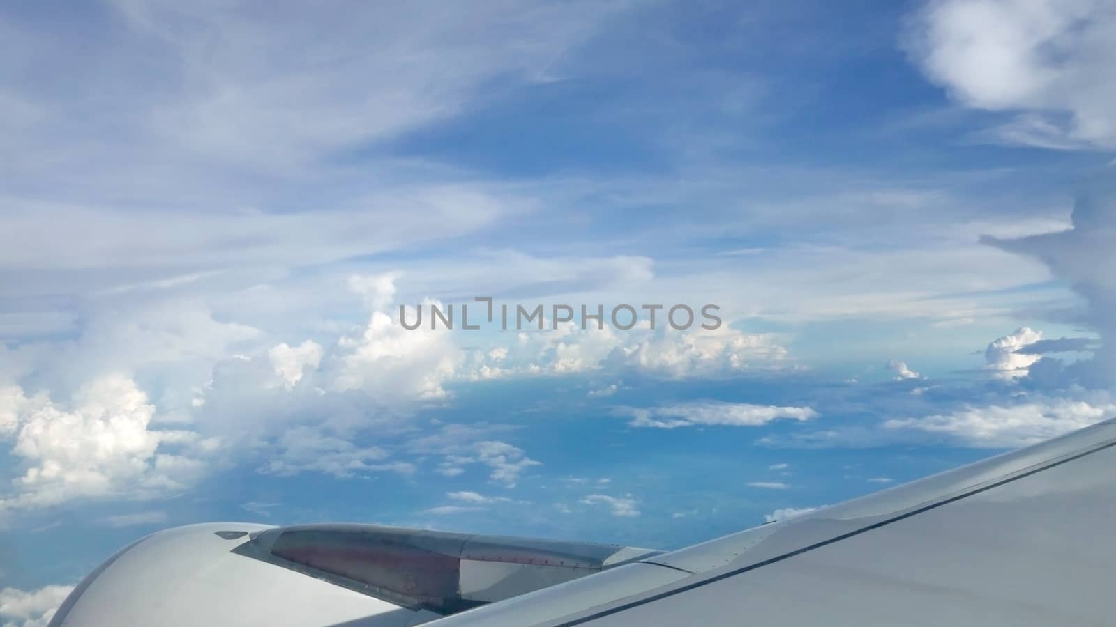 Blue sky cloudscape background and wing of airplane  by cougarsan