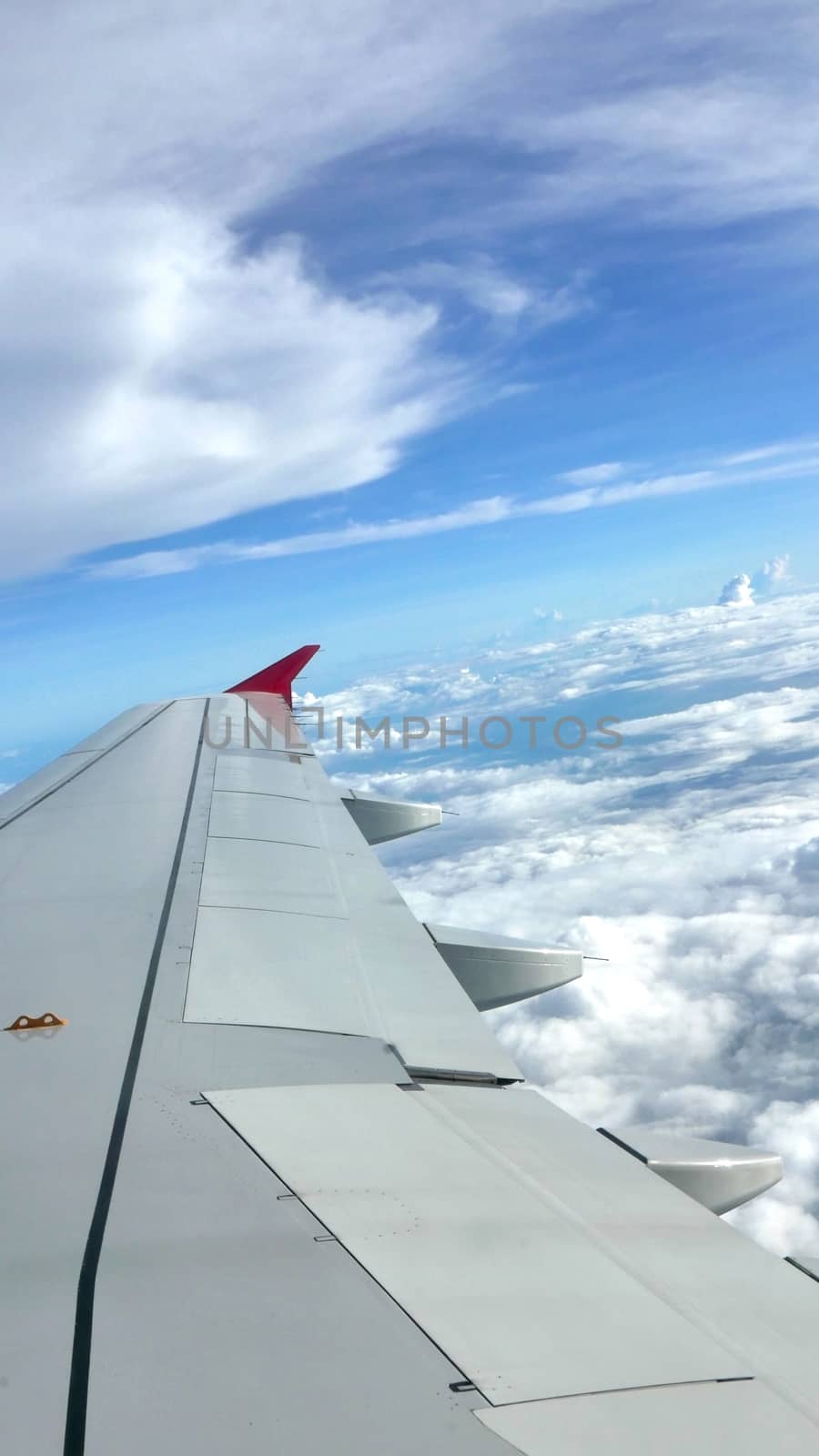 Blue sky cloudscape background and wing of airplane  by cougarsan