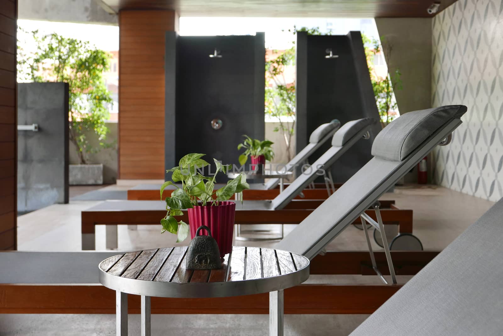 few suntan chair, small table, decoration near the swimming pool